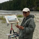 artist painting on the beach