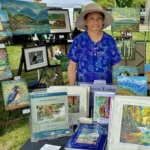 Artist with paintings